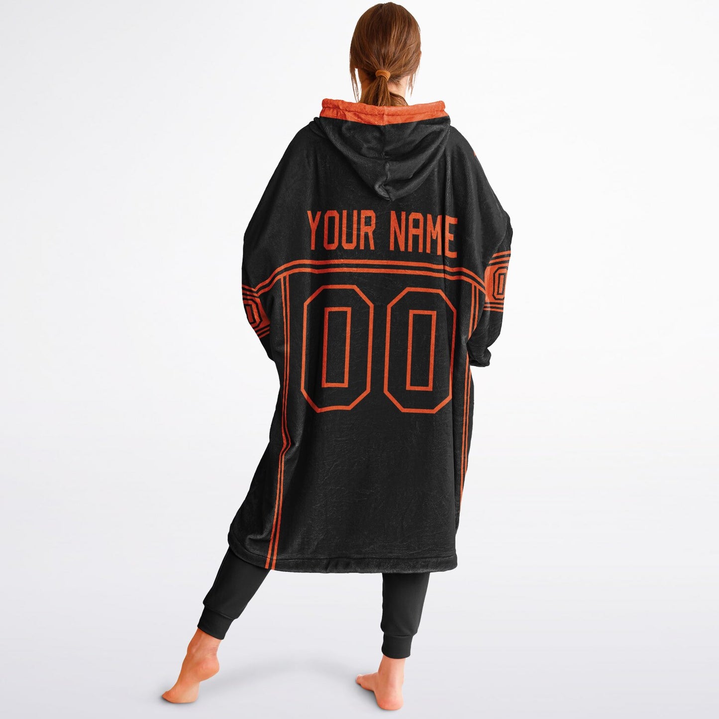 Black and orange lineup snug hoodie featuring sleek line-art details and minimalist team-inspired design.