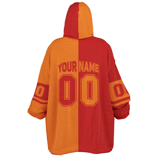 Red and orange halftime snug hoodie featuring a symmetrical split design for a dynamic game-day look.