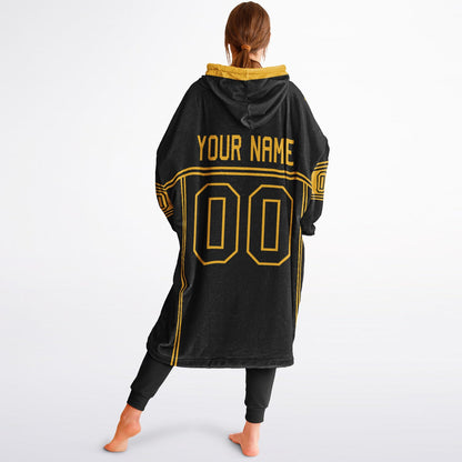 Black and gold lineup snug hoodie featuring sleek line-art details and minimalist team-inspired design.