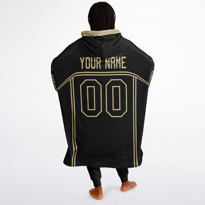 Black and old gold lineup snug hoodie featuring sleek line-art details and minimalist team-inspired design.