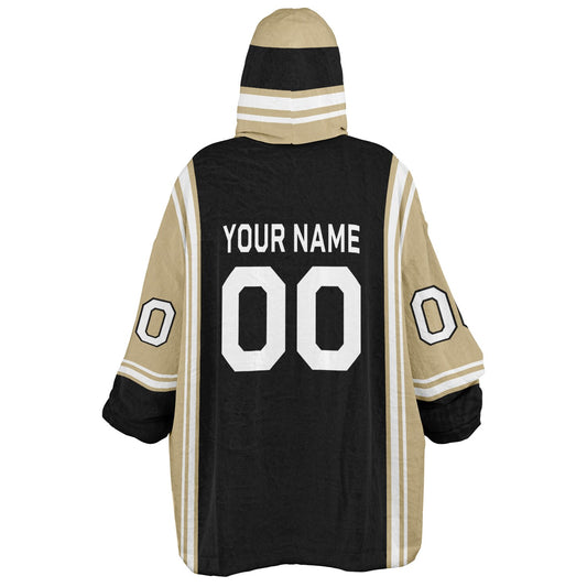 Black, old gold, and white bold snug hoodie with triple color blocking and a sporty aesthetic.