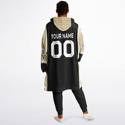 Black, old gold, and white bold snug hoodie with triple color blocking and a sporty aesthetic.