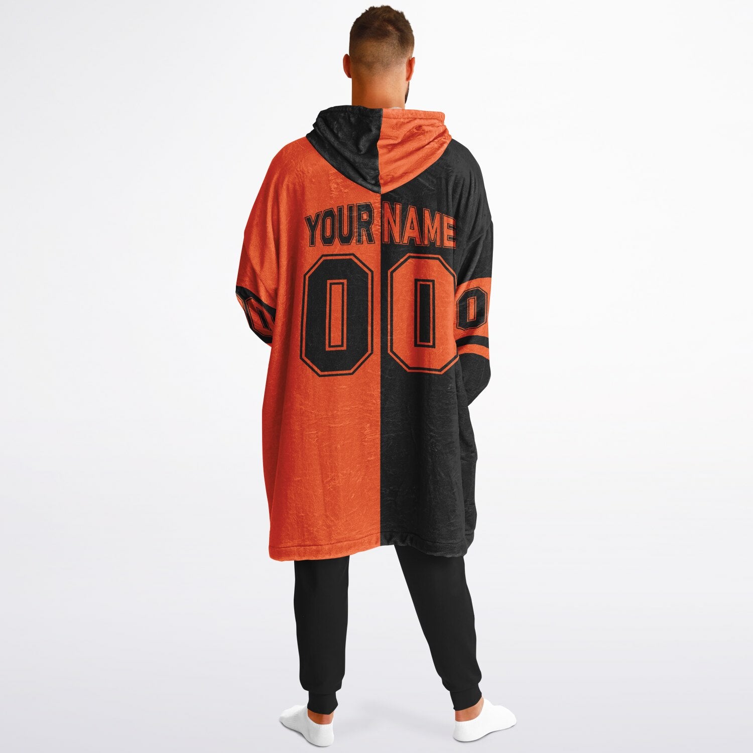 Black and orange halftime snug hoodie featuring a symmetrical split design for a dynamic game-day look.