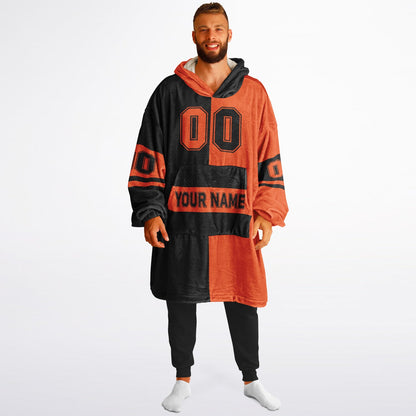 Black and orange halftime snug hoodie featuring a symmetrical split design for a dynamic game-day look.