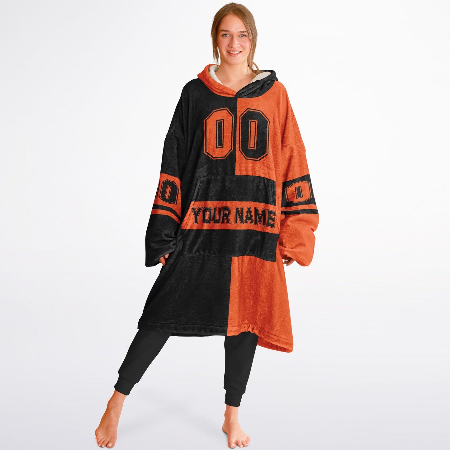 Black and orange halftime snug hoodie featuring a symmetrical split design for a dynamic game-day look.