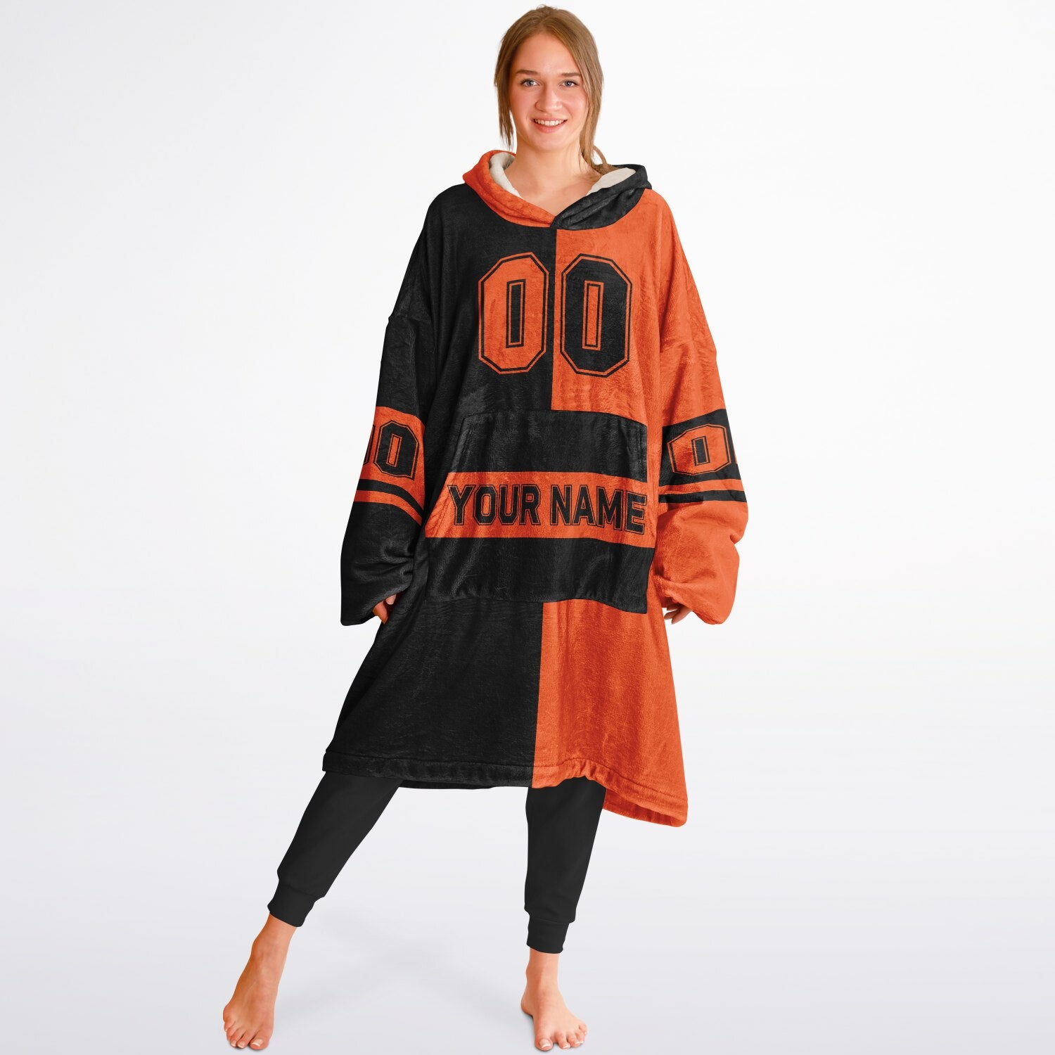 Black and orange halftime snug hoodie featuring a symmetrical split design for a dynamic game-day look.
