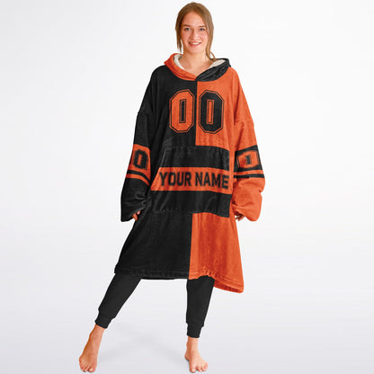 Black and orange halftime snug hoodie featuring a symmetrical split design for a dynamic game-day look.