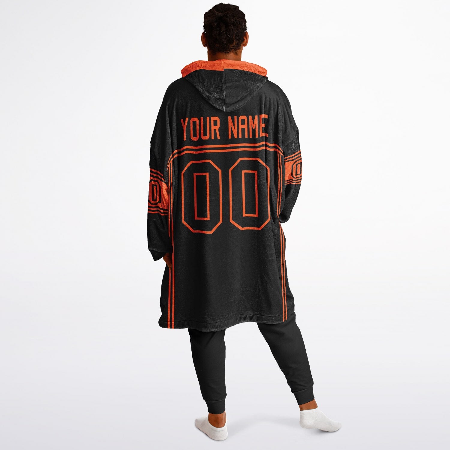 Black and orange lineup snug hoodie featuring sleek line-art details and minimalist team-inspired design.