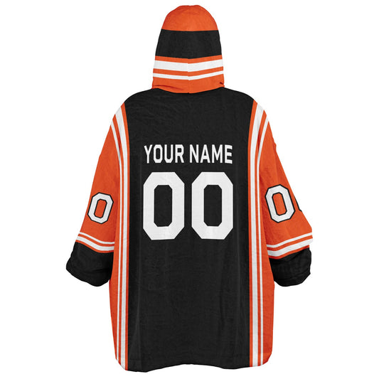 Black, orange, and white bold snug hoodie with triple color blocking and a sporty aesthetic.