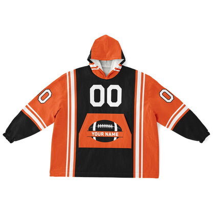 Black, orange, and white bold snug hoodie with triple color blocking and a sporty aesthetic.