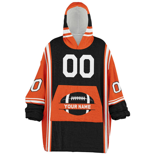 Black, orange, and white bold snug hoodie with triple color blocking and a sporty aesthetic.