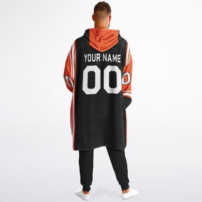 Black, orange, and white bold snug hoodie with triple color blocking and a sporty aesthetic