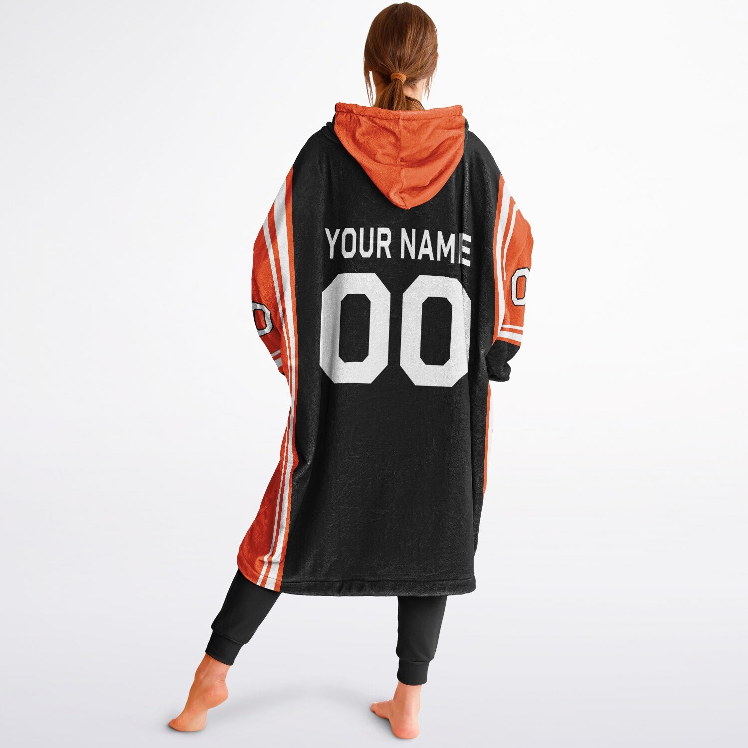 Black, orange, and white bold snug hoodie with triple color blocking and a sporty aesthetic.
