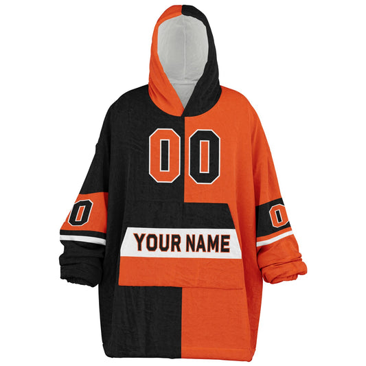 Black, orange, and white halftime snug hoodie with three-tone split design and cozy fleece texture.