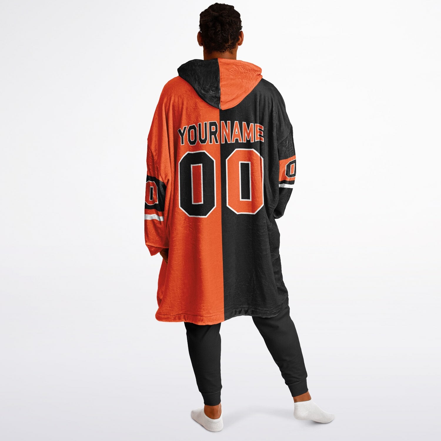 Black, orange, and white halftime snug hoodie with three-tone split design and cozy fleece texture.