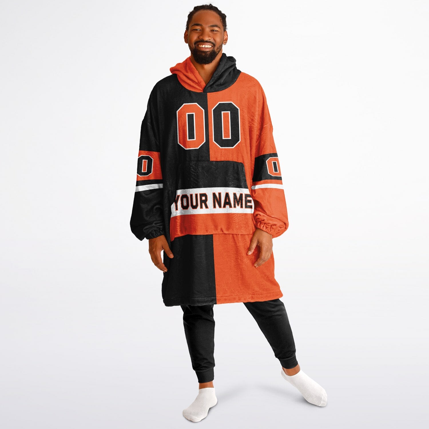 Black, orange, and white halftime snug hoodie with three-tone split design and cozy fleece texture.