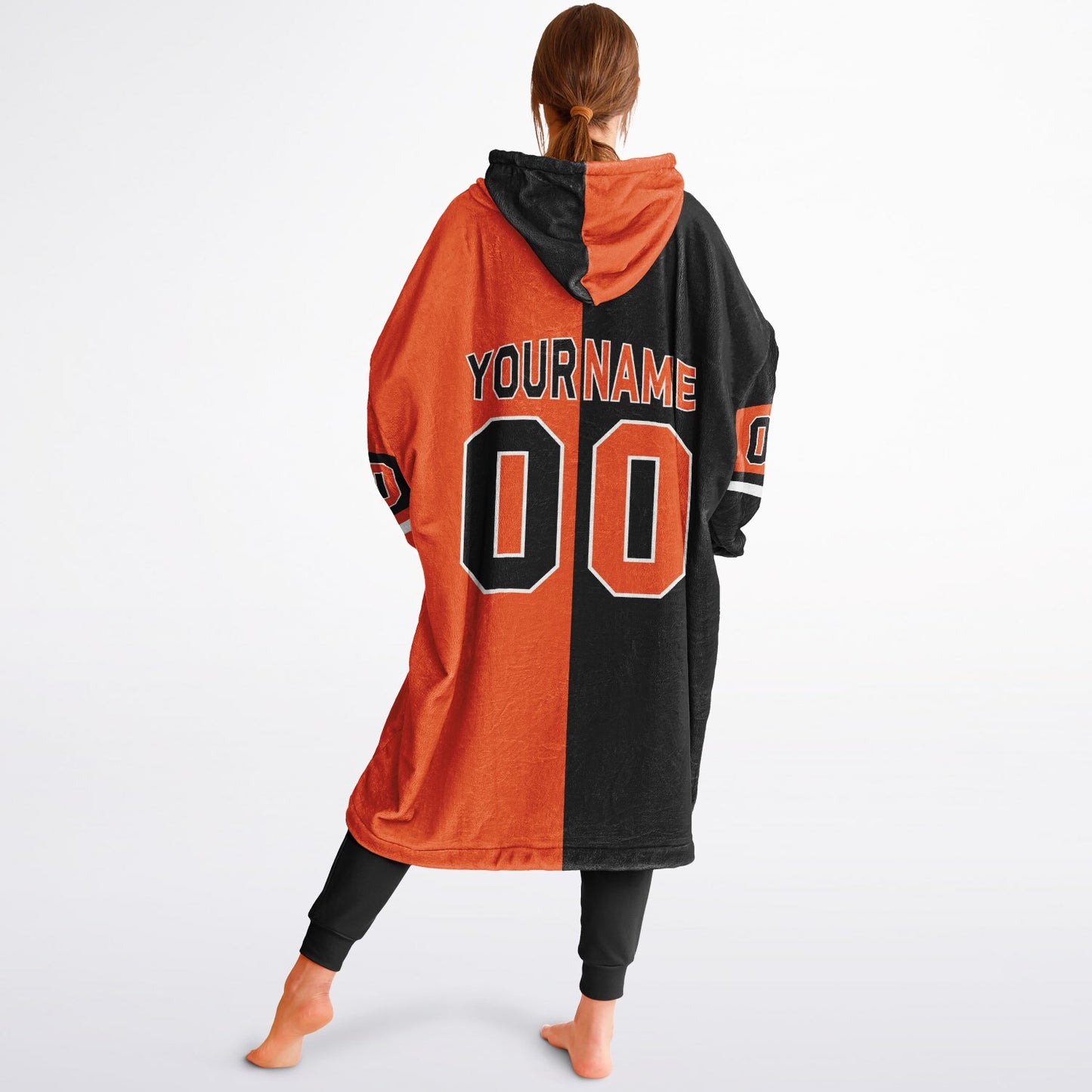 Black, orange, and white halftime snug hoodie with three-tone split design and cozy fleece texture.