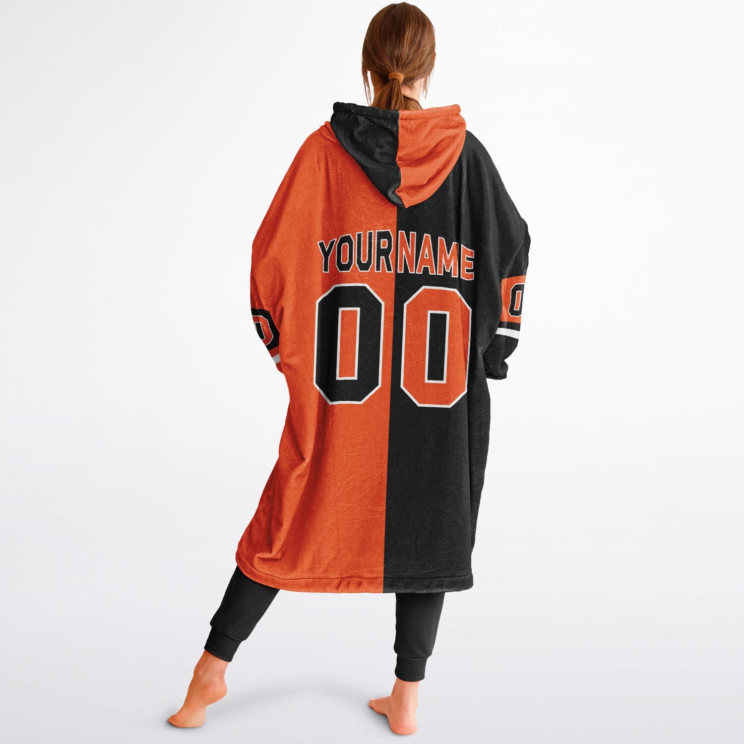 Black, orange, and white halftime snug hoodie with three-tone split design and cozy fleece texture.