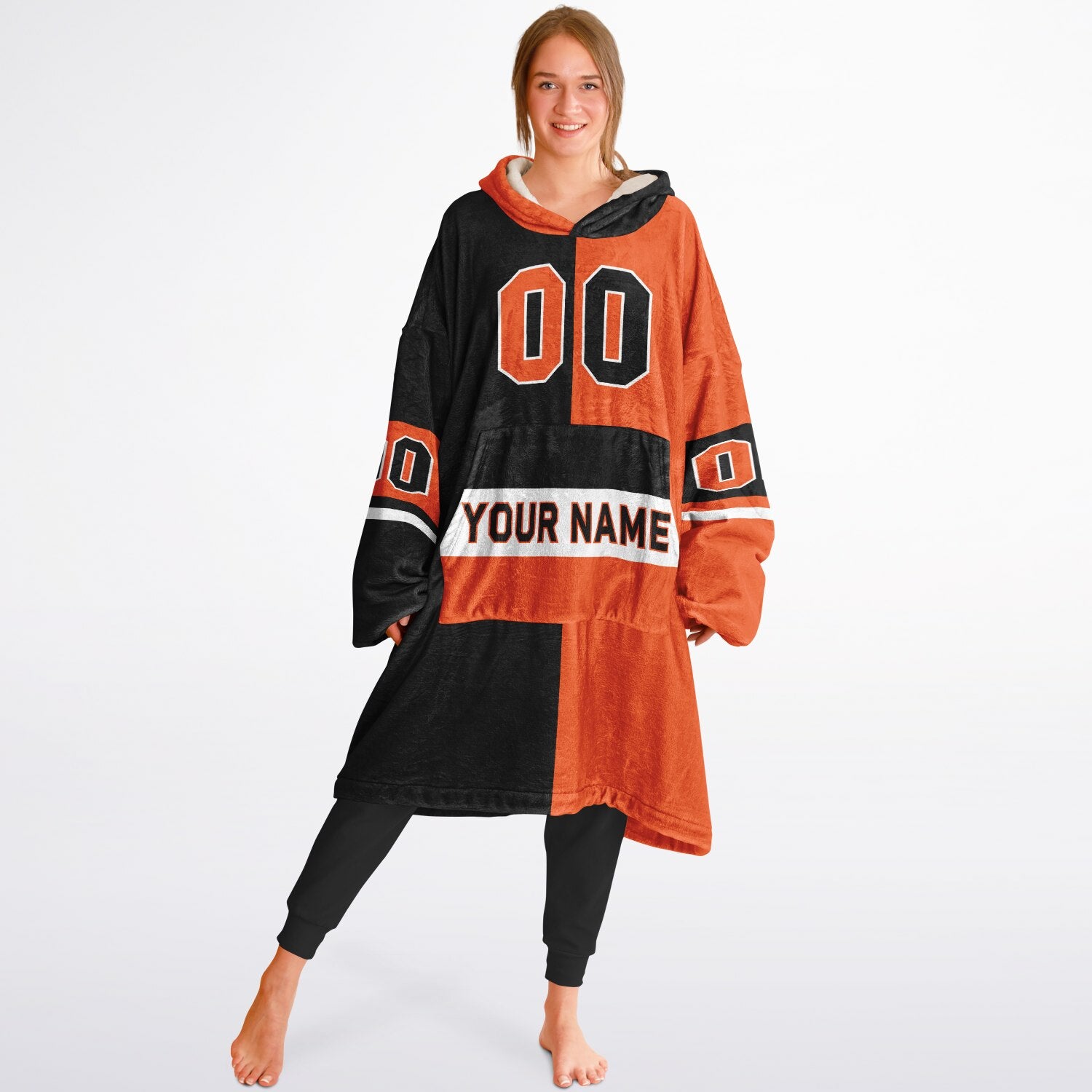Black, orange, and white halftime snug hoodie with three-tone split design and cozy fleece texture.