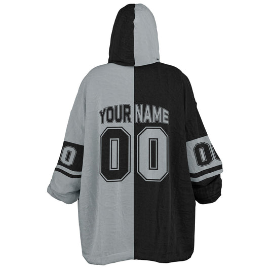 Black and silver halftime snug hoodie featuring a symmetrical split design for a dynamic game-day look.