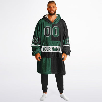 Green, black, and white halftime snug hoodie with three-tone split design and cozy fleece texture.