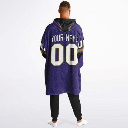 Purple, black, and metallic gold classic snug hoodie featuring authentic jersey striping and personalized number details.