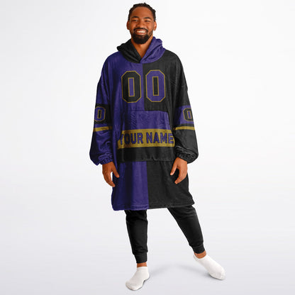 Purple, black, and metallic gold halftime snug hoodie with three-tone split design and cozy fleece texture.