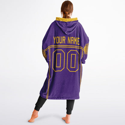 Purple and gold lineup snug hoodie featuring sleek line-art details and minimalist team-inspired design.