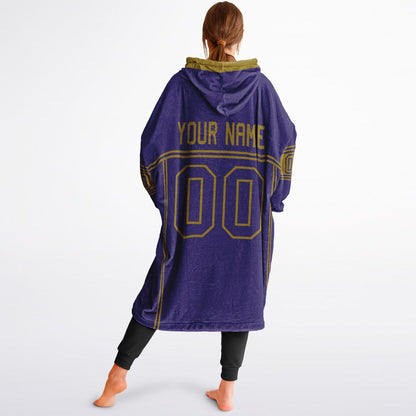 Purple and metallic gold lineup snug hoodie featuring sleek line-art details and minimalist team-inspired design.