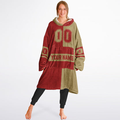 Red and metallic gold halftime snug hoodie featuring a symmetrical split design for a dynamic game-day look.